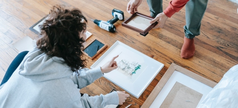 A couple packing paintings and canvases