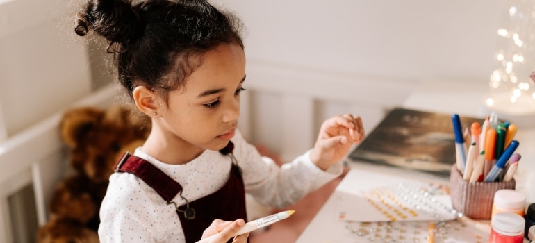 A girl painting at a workshop - one of the best things to do In Hallandale Beach with kids