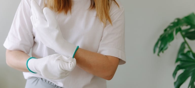 A woman with white gloves