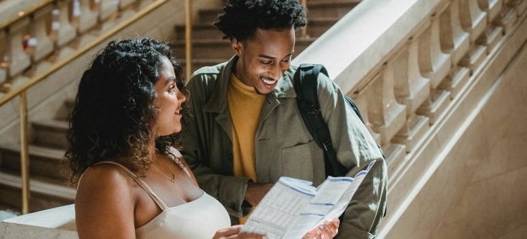 Two people looking at a map after moving from Aventura to Coral Gables