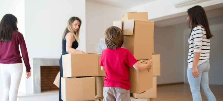 a family carrying boxes