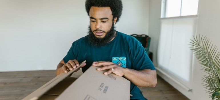 a professional mover packing a box