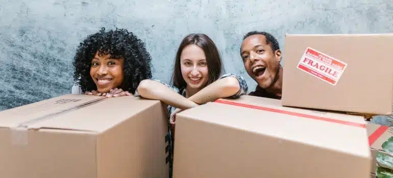 smiling friends surrounded by boxes