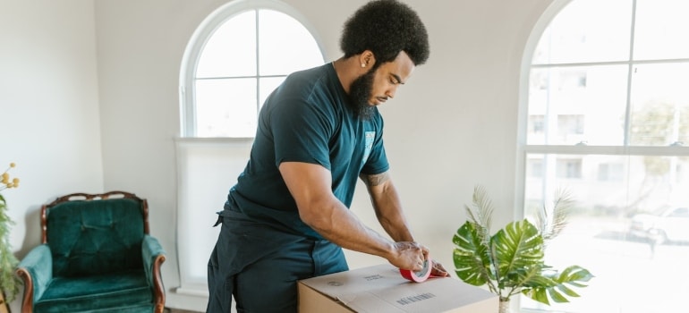 a mover packing a box