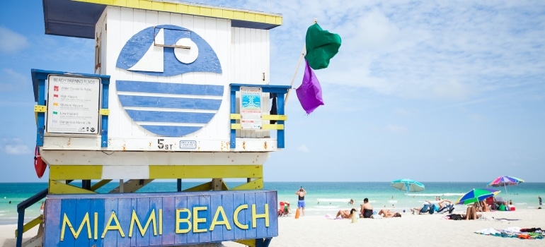 people enjoying Miami Beach's sandy beach, one of the best summer things to do in Miami Beach