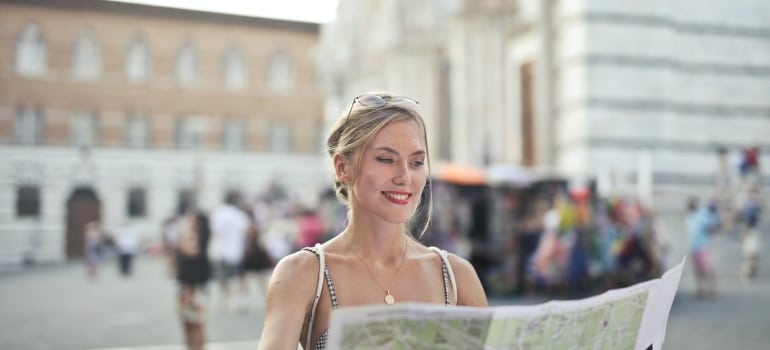 a woma holding a map looking for best places in Broward County