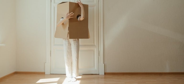 a woman with a carboard box on her head