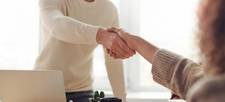 people shaking hands after agreeing how to pack your condo when moving to Miami beach