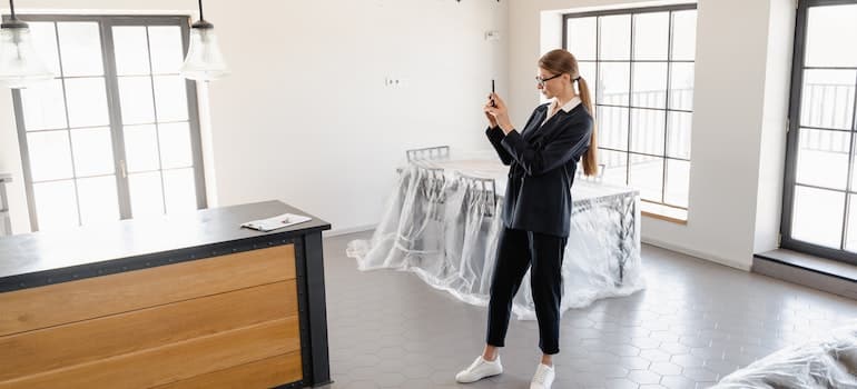 Woman taking pictures of furniture.