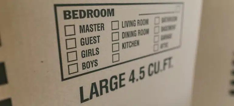 A brown cardboard box with detailed label for decluttering