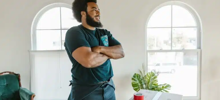 a mover standing next to a box 