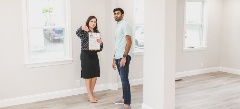 a man inspecting a home with a real estate agent