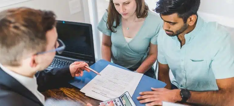 a real estate agent showing data about Miami Dade real estate to a couple