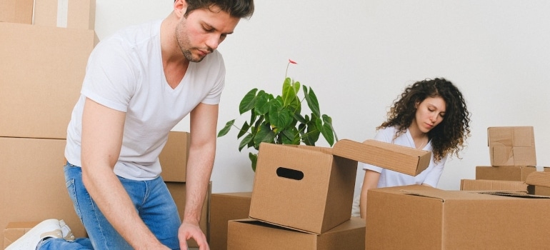 a coupe packing boxes trying to declutter your home storage with ease