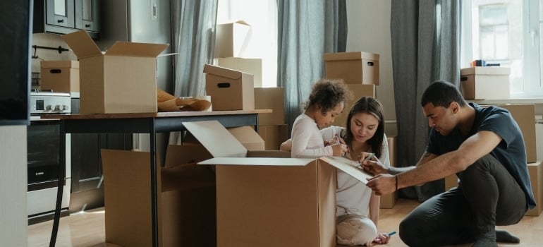 a family surrounded by boxes planning how tohave fun after moving to South Point 