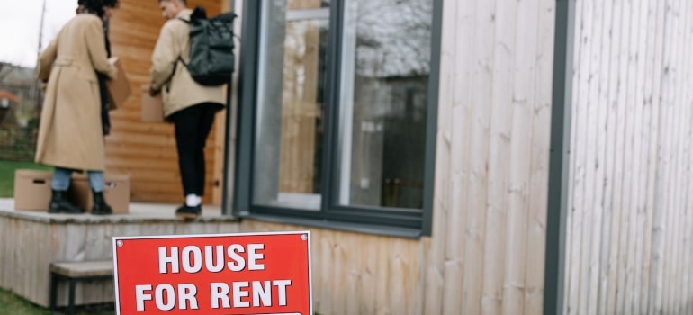 house for rent sign posted by a couple before their move from Fort Lauderdale to another state