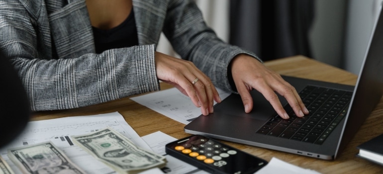 a woman calculating her expenses before her move from Fort Lauderdale to another state