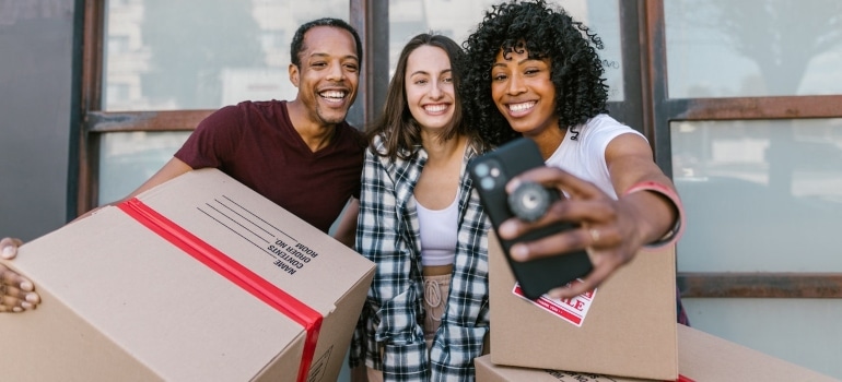 happy people taking a selfie before the move