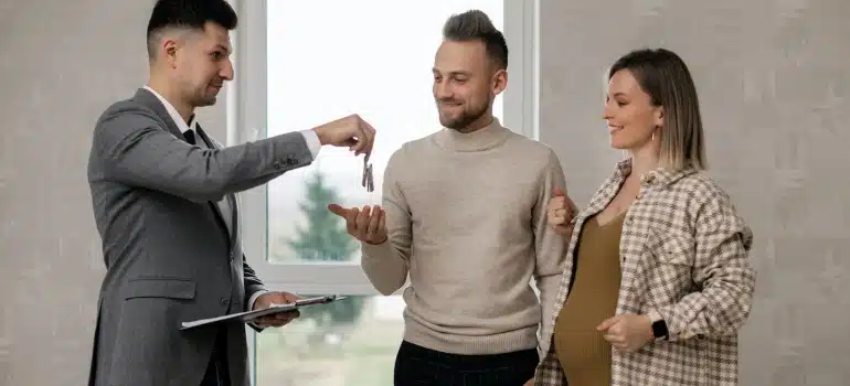 a couple with a real estate agent about to invest in Coral Spring's real estate