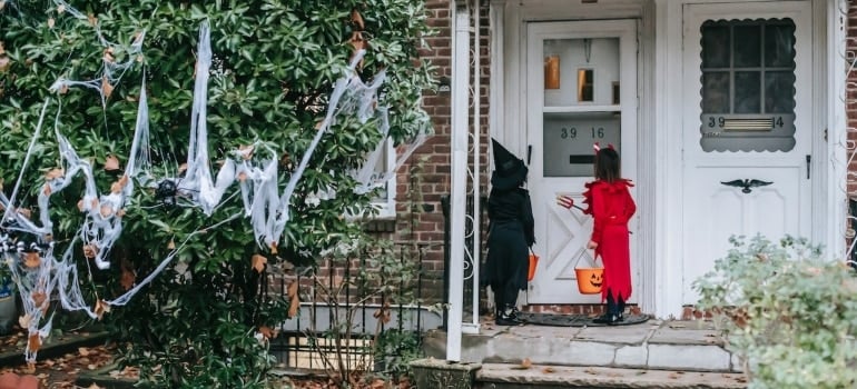Halloween outdoor decor and children in front of a house