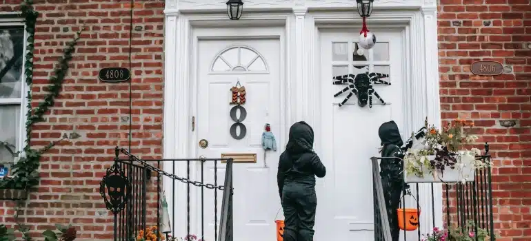 children in the Halloween outfit in a doorstep 