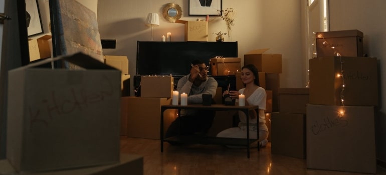 a couple surrounded by boxes in a romantic atmosphere