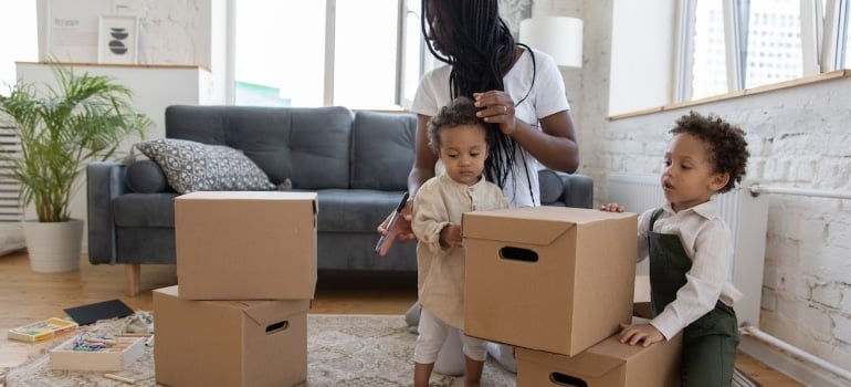 A woman unpacking with kids