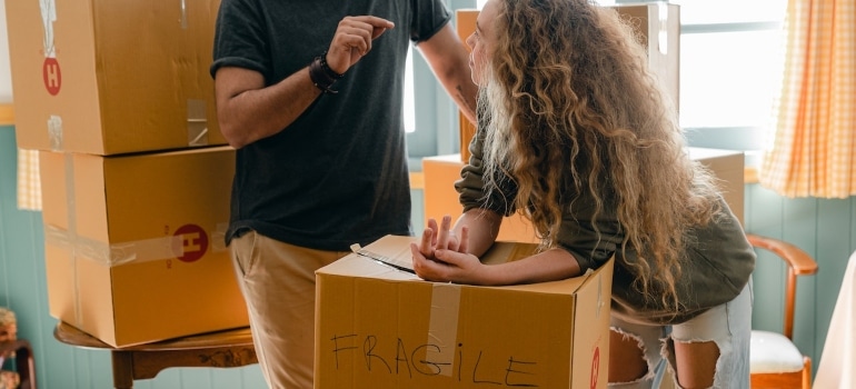 A couple talking about how to pack fragile chandeliers for moving to Coconut Grove