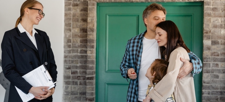 A family with a real estate agent checking Coral Springs real estate