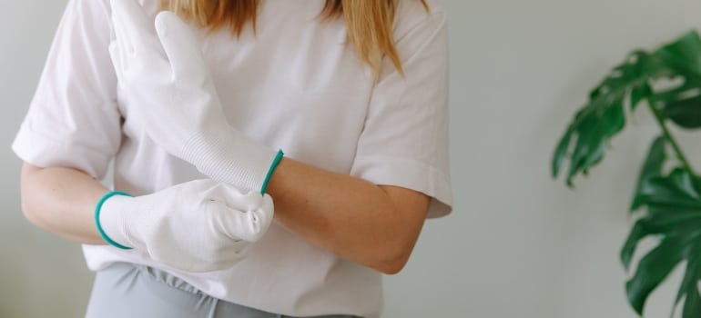 a woman wearing white gloves 