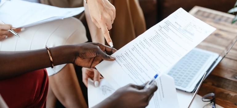 people reading a document about South Florida's moving regulations