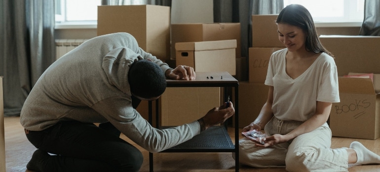 a man disassembling a table and about to store luxury furniture in Miami