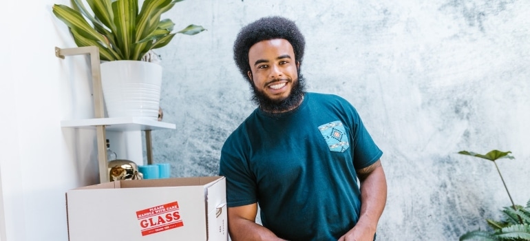 a happy mover next to a box labeled fragile