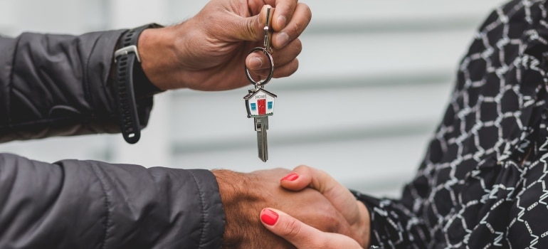 a person handing the keys