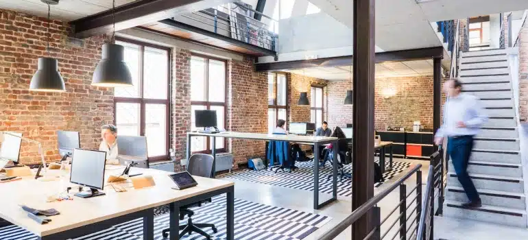 many people in an office looking for ways to declutter your office when moving to North Miami