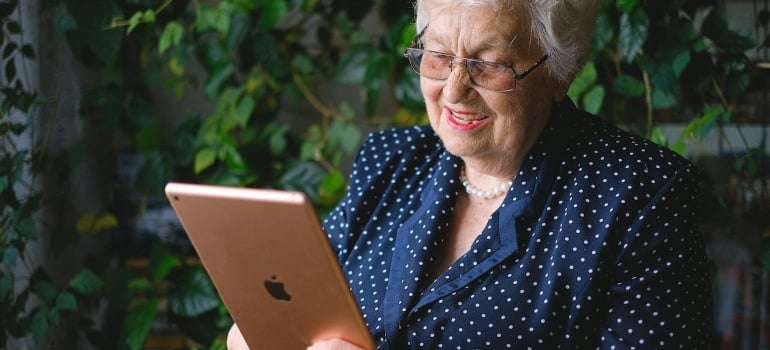 a woman exploring the best places to retire in Miami Dade County on her ipad