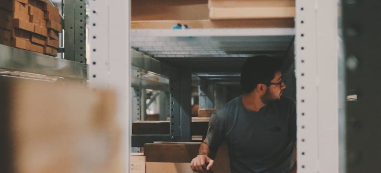 a man in storage thinking about how to store your Christmas decorations