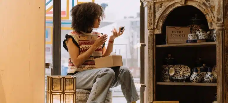 a woman about to pack and move handmade items
