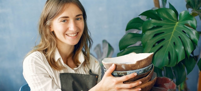a woman holding pottery