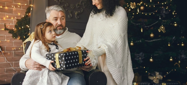 A family in their home sharing gifts 