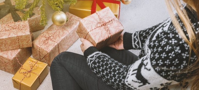 a woman making Christmas gifts before moving during Christmas holidays