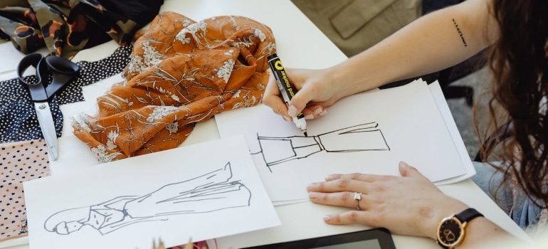 a woman drawing a dress