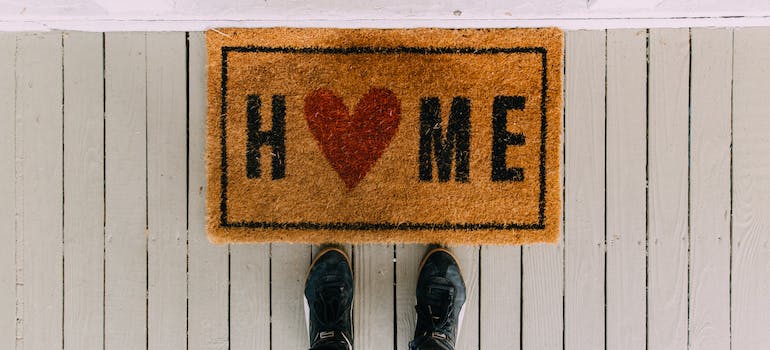 black shoes in front of little carpet with home sign