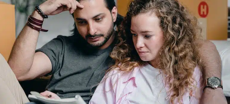 a man and a woman reading from a notebook