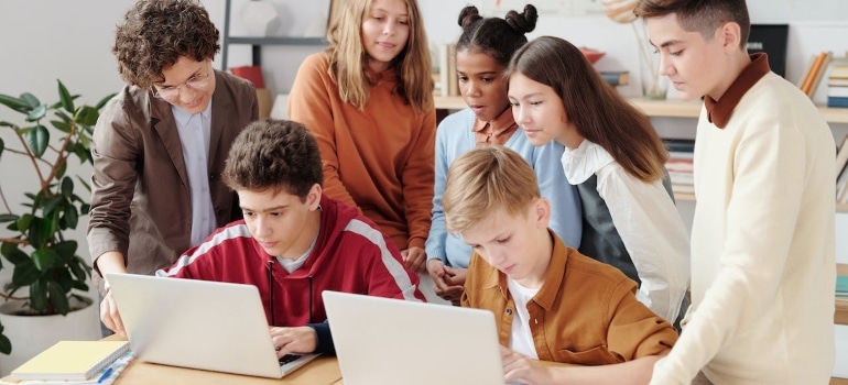 Teenagers browsing on a laptop