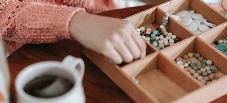 a woman packing pieces for handmade jewelry