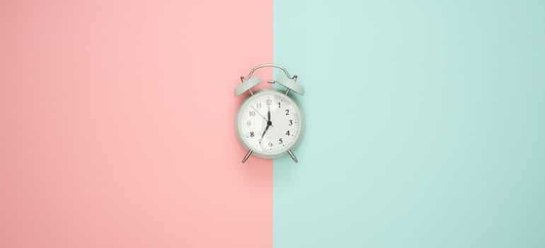 a clock on a pink and blue background