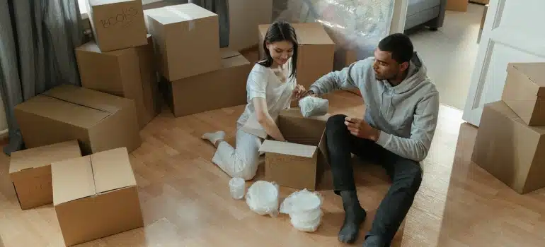 a couple packing for the move