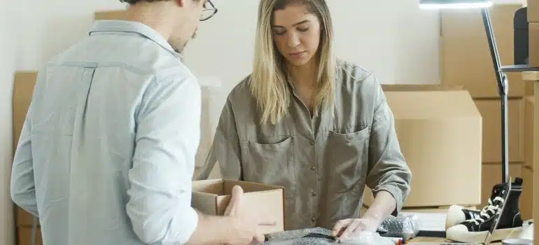 two people packing and talking about how to combine different types of moving services when moving in Florida