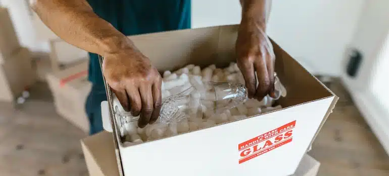a man packing a glass providing luxury moving services in  Miami Beach